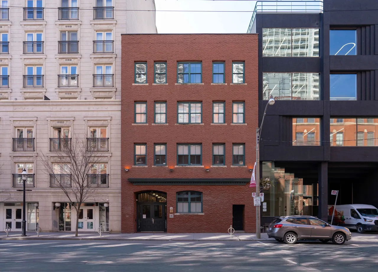 Street of heritage building facades with an office tower beyond